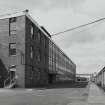 View from E showing disused office block (left), and W end of Broadloom Department (right).