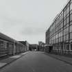 View from W showing disused office block (right), Broadloom Weaving Department (left), and former Madelvic Car Factory (including pend) in distance