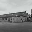 View from SE of Wire Division, showing North Mill, with boiler house and chimney in background.  The mill draws mostly brass rod into wire/