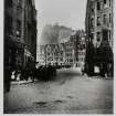 Photographic copy of postcard view.  Grassmarket from the junction of the Cowgate and Candlemakers Row with the Castle in the backgorund.