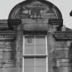 Detail of finialled segmental-headed dormer pediment with initials