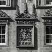 Courtyard. W range. Detail of carved panel above doorway