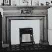 Interior-detail of blocked fireplace with gas heater in situ in Room G.01