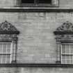 Two carved frontispieces at N facade