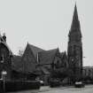 View from North East showing church and later extensions.