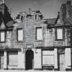 Newhaven, Fishermen's Hall, 56-58 Main Street, and 12 Pier Place.
View from South of four bay main elevation prior to restoration, showing crow-stepped gables, flower-motif finials and stepped hood mould over Main Street entrance.