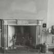 Fireplace decorated with marble and showing carvings of classical urns