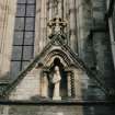 Detail of main entrance in SW elevation showing right hand gable with niche and modern sculpture bust.