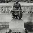 Detail of soldier with wreaths at base of statue.