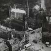 Oblique aerial view from the northwest of the West End of Princes Street showing St John's Church, St Cuthbert's Church, Maules Store (now Frasers) and part of the Caledonian Hotel.