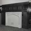 Ground floor, reception area, fireplace with wood panelling surround, detail.