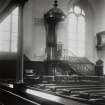 Interior showing pulpit and former windows.