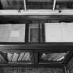 Interior. Library, view of glass case containing manuscripts