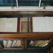 Interior. Library, view of glass case containing manuscripts