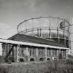 Edinburgh, Granton Gasworks, Meter House
General view from SW with gasholders nos. 1 (c.1899) and 3 (c.1969) behind. The pipes are the common leg gas flow and return to gasholders installed in c.1969