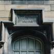 Detail of carved panel above doorway on north side of courtyard