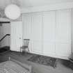 Interior. Fourth floor. Front bedroom showing panelled cupboards closed