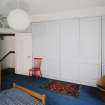 Interior. Fourth floor. Front bedroom showing panelled cupboards closed