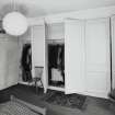 Interior. Fourth floor. Front bedroom showing panelled cupboards open