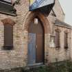 Front door detail, showing the local yellow fireclay brick walls, and the red brick voussoirs