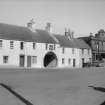 General view of nos 51, 53, 59, 59 Goarge Street and Whithorn Priory archway.