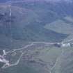 Oblique aerial view centred on the mine and buildings with farmstead adjacent, taken from the SW.