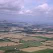 General oblique aerial view looking across Monkrigg towards Haddington with North Berwick Law and the Bass Rock beyond, taken from the SSW.