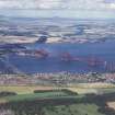 Aerial view of the Forth Railway Bridge and the Forth Road Bridge seen from the South West across the fields of South Queensferry.
