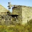 Rusness, Sunibrae: View from SE of wind-engine tower and remains with threshing-barn gable on L