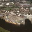 Oblique aerial view of Clydebank centred on John Brown's Shipyard and crane, taken from the SW.
