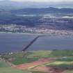 Oblique aerial view looking across River Tay and railway bridge towards the City of Dundee and Grampian mountains, taken from the ESE.