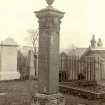 Historic photograph showing view of column in churchyard carved by Archibald Handyside.