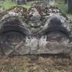 View of part buried headstone  with crossbones and possible Green Man,  Dun Old  Parish Churchyard.