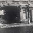 Detailed view of the pend leading to St Patrick Square, Edinburgh and the shopfront of No. 25 seen from the West.