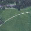 Oblique aerial view centred on the cropmarks of the country house with cathedral adjacent, taken from the N.