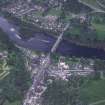 Oblique aerial view centred on the town of Dunkeld with road bridge and cathedral adjacent, taken from the NW.