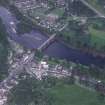 Oblique aerial view centred on the town of Dunkeld with road bridge and cathedral adjacent, taken from the NW.