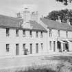 General view of 1-2 Polnoon Street, Eaglesham, from SW, including the premises of the Glasgow South Co-Operative Society United.