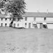 General view of 1-2 Polnoon Street, Eaglesham, from S, including the premises of the Glasgow South Co-Operative Society United.